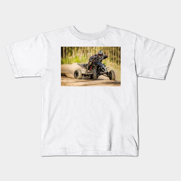 ATV racer takes a turn during a race. Kids T-Shirt by homydesign